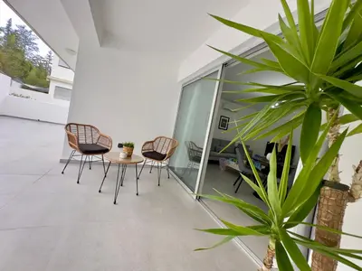 a patio with chairs and a table and a plant at Panorama Residence in Nicosia