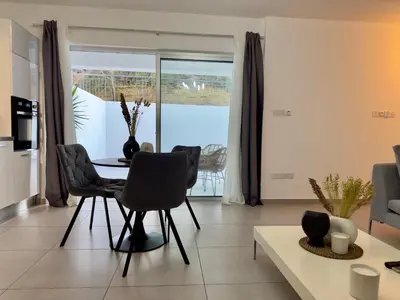 a living room with a table and chairs at Panorama Residence in Nicosia