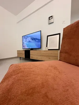 a bedroom with a bed and a flat screen tv at Panorama Residence in Nicosia