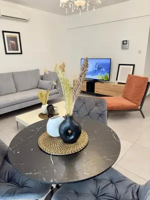 a living room with a table with a vase on it at Panorama Residence in Nicosia