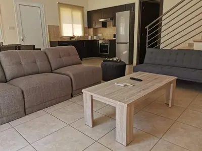 a living room with two couches and a coffee table at Mythical Sands BG03 townhouse in Paralimni