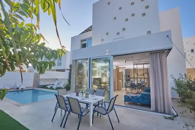 a patio with a table and chairs next to a pool at Protaras Vie Bleu Villa Vb8 in Protaras