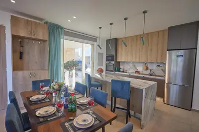 a kitchen and dining room with a table and chairs at Protaras Vie Bleu Villa Vb8 in Protaras