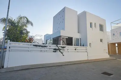 a white building with a fence in front of it at Protaras Vie Bleu Villa Vb8 in Protaras