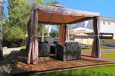 a wooden deck with a gazebo in a yard at Villa Crystalia - 350m from Kalamies Beach in Protaras