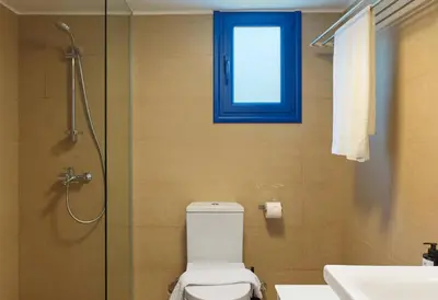 a bathroom with a toilet and a shower and a window at Villa Orchard by Tangerine in Protaras