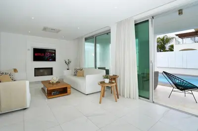 a living room with a couch and a tv at Villa Indigo in Protaras