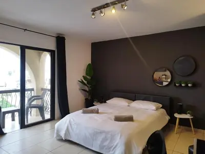 a bedroom with a bed with a black wall at 303 St Lazaros View Studio in Larnaka