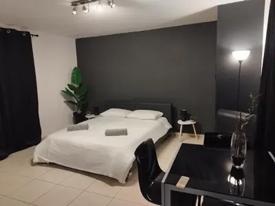 a bedroom with a white bed and a table and a table sidx sidx at 303 St Lazaros View Studio in Larnaka