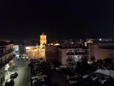 a view of a city at night with a clock tower at 303 St Lazaros View Studio in Larnaka
