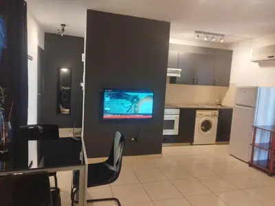 a living room with a tv on a wall at 303 St Lazaros View Studio in Larnaka