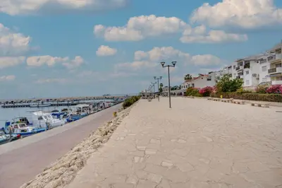 a sidewalk next to a marina with boats at Glabur Stays! The One -1 - Elite Marina Front! in Zygi