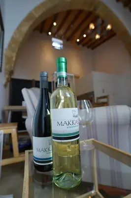 two bottles of wine sitting on a table with a glass at Large Kamara Studio in Nicosia