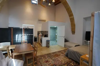 a living room with a table and a dining room at Large Kamara Studio in Nicosia