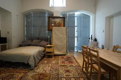 a living room with a bed and a table at Large Kamara Studio in Nicosia