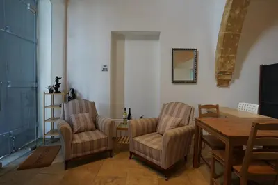 a living room with two chairs and a table at Large Kamara Studio in Nicosia