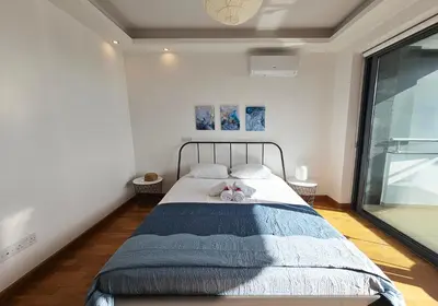 a bedroom with a bed with two stuffed animals on it at Dios Ponte Finikoudes Beachfront in Larnaka