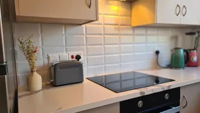 a kitchen counter with a sink and a toaster at STAY Sunlit Apartment in Limassol