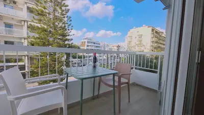 a balcony with a table and chairs and a window at STAY Sunlit Apartment in Limassol