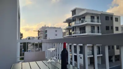 a bottle of wine sitting on a balcony at STAY Sunlit Apartment in Limassol