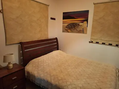 a bedroom with a bed and a picture on the wall at Koukaki in Kouka