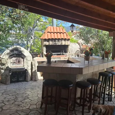 a outdoor bar with a stone oven in a patio at Koukaki in Kouka