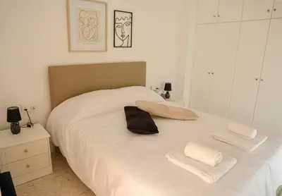 a bedroom with a white bed with towels on it at Cozy 2 Bdr Nicosia City Free Parking Wifi in Nicosia