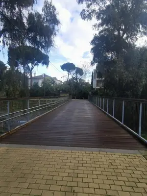 a bridge in a park with trees and a fence at Cozy 2 Bdr Nicosia City Free Parking Wifi in Nicosia