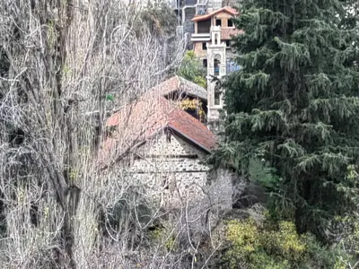a building with a red roof and some trees at PITHARIA in Askas