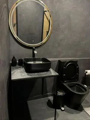 a bathroom with a sink and a mirror and a toilet at River Glamping Kalopanayiotis in Kalopanayiotis