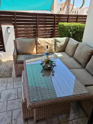 a coffee table on a patio with a couch at Villa Ocean Breeze in Paralimni