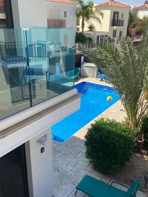 a view of a swimming pool from the balcony of a house at Villa Ocean Breeze in Paralimni