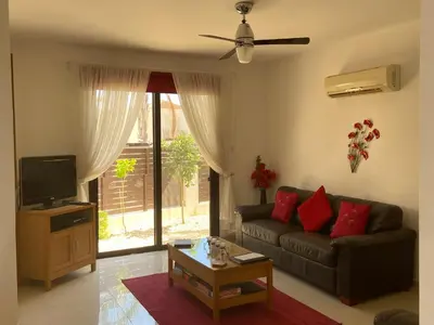 a living room with a couch and a tv at Villa Ocean Breeze in Paralimni