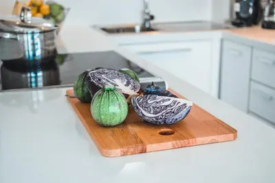 three vegetables on a cutting board on a kitchen counter at Protaras Beachfront Thalassa Suite in Protaras
