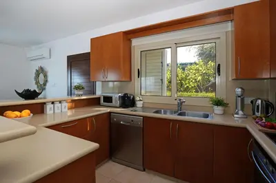a kitchen with a sink and a window at Cape Panorama Villa in Protaras