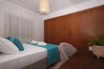 a bedroom with a bed with a table and a chair at Cape Panorama Villa in Protaras