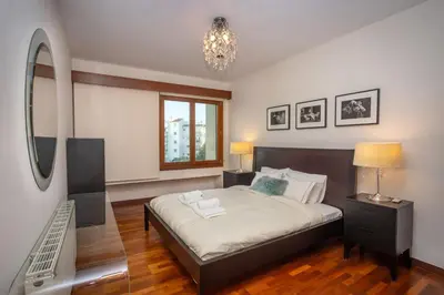 a bedroom with a large bed and a mirror at Hallmark Beach by TrulyCyprus in Limassol