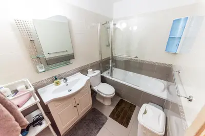 a bathroom with a sink and a toilet and a mirror at 3 bed, Kapparis, Thea - 3A in Paralimni