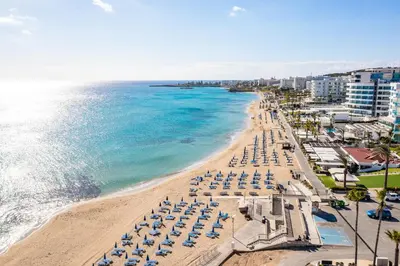 an aerial view of a beach with umbrellas and the ocean at Studio in Protaras in Protaras