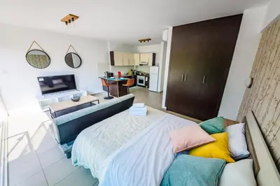 a bedroom with a large bed and a living room at Studio in Protaras in Protaras