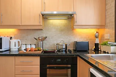 a kitchen with a black stove top oven next to a sink at Villa Maya - 4bed with Private Heated Pool in Paralimni