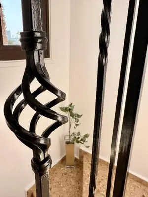 a black chair in a room with a plant at Villa Hera in Ayios Theodhoros