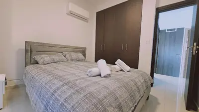 a bedroom with a bed with two pillows on it at STAY Cosmo City Suites in Nicosia