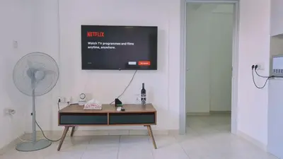 a tv hanging on a wall in a room at STAY Finikoudes Soul in Larnaka