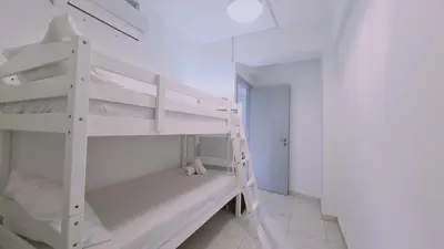 a white bunk bed in a white room with a ladder at STAY Finikoudes Soul in Larnaka
