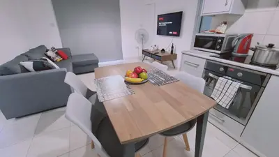 a kitchen with a table with a bowl of fruit on it at STAY Finikoudes Soul in Larnaka