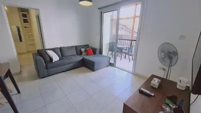 a living room with a couch and a table at STAY Finikoudes Soul in Larnaka