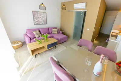 a living room with a purple couch and a table at Apartament De Lux MS 1 - C in Paralimni