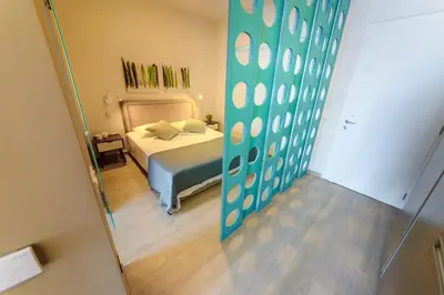 a small bedroom with a bed and a mirror at Apartament De Lux MS 1 - C in Paralimni