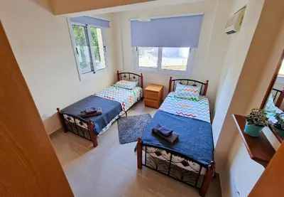 a room with two beds and a window at 3 bed, Kapparis, Thea - 3C in Paralimni